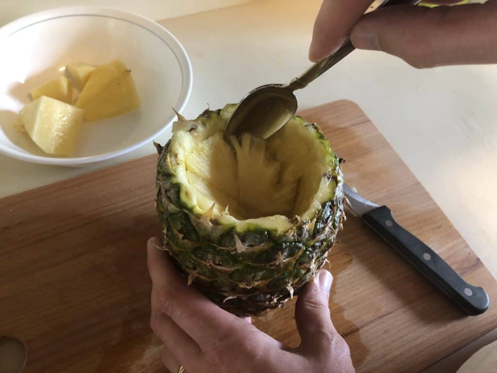 Hallow the pineapple with a spoon.